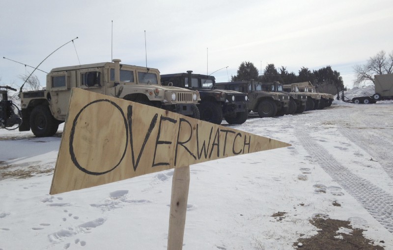 Military vehicles are staged near the path of the Dakota Access pipeline. CREDIT: AP Photo/James MacPherson