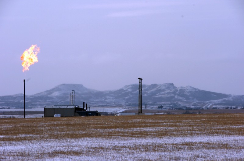 A gas flare is seen at a natural gas processing facility near Williston, N.D. CREDIT: AP Photo/Matthew Brown