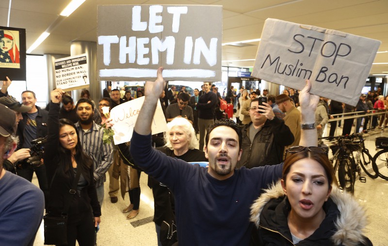 Supporters cheer as an Iranian citizen with a valid U.S. visa arrives at Los Angeles International Airport, Feb. 2, 2017. CREDIT: AP/Damian Dovarganes