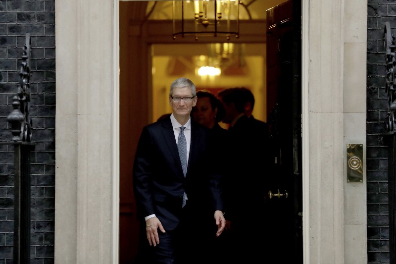 Apple CEO Tim Cook waves at members of the media as he leaves 10 Downing Street in London, Thursday, Feb. 9, 2017. CRDIT: AP Photo/Matt Dunham