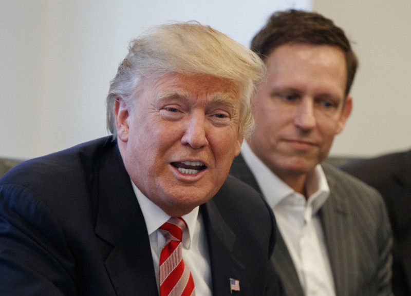 Peter Thiel listens to then President-elect Donald Trump at a December 14, 2016 meeting at Trump Tower. CREDIT: AP/Evan Vucci