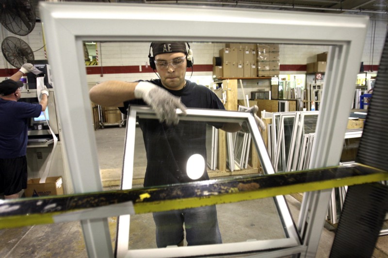A Michigan factor worker builds efficient windows for weathering homes. AP Photo/Carlos Osorio