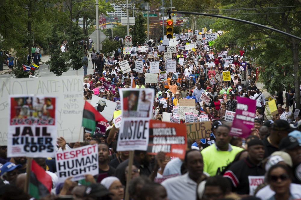 Demonstrators march to protest the death of Eric Garner in the Staten Island borough of New York. CREDIT: AP Photo/John Minchillo