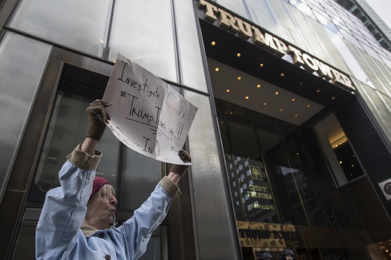A supporter of President Donald Trump chants holds a sign calling for an investigation of the Trump Tower wire taping during a rally on Fifth Avenue near Trump Tower, Saturday, March 4, 2017, in New York. CREDIT: AP Photo/Mary Altaffer