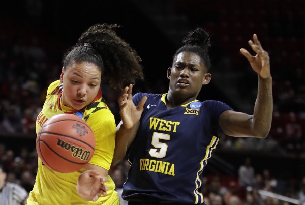 Maryland guard Destiny Slocum, left, chases after the ball as she collides with West Virginia guard Tynice Martin. CREDIT: AP Photo/Patrick Semansky