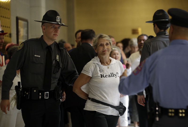 A “Moral Mondays” protester is arrested at the North Carolina capitol in 2013. CREDIT: AP Photo/Gerry Broome, File