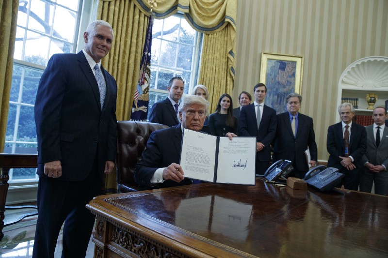 President Donald Trump shows his signature on an executive order on the Keystone XL pipeline, Tuesday, Jan. 24, 2017. CREDIT: AP Photo/Evan Vucci
