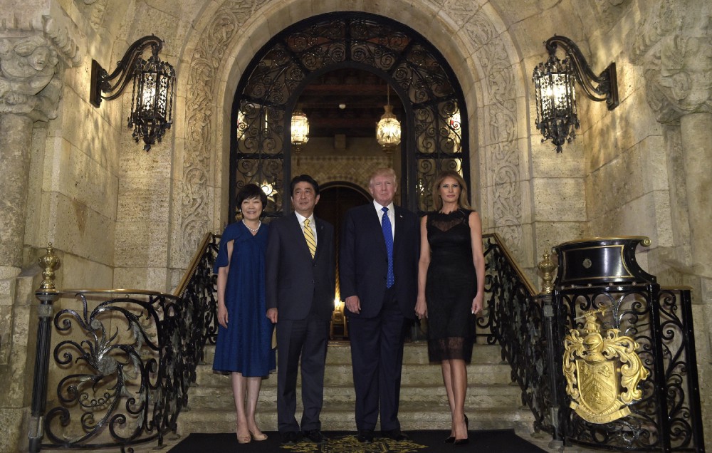 President Donald Trump and first lady Melania Trump stop to pose for a photo with Japanese Prime Minister Shinzo Abe and his wife Akie Abe before they have dinner at Mar-a-Lago on February 11. CREDIT: AP Photo/Susan Walsh