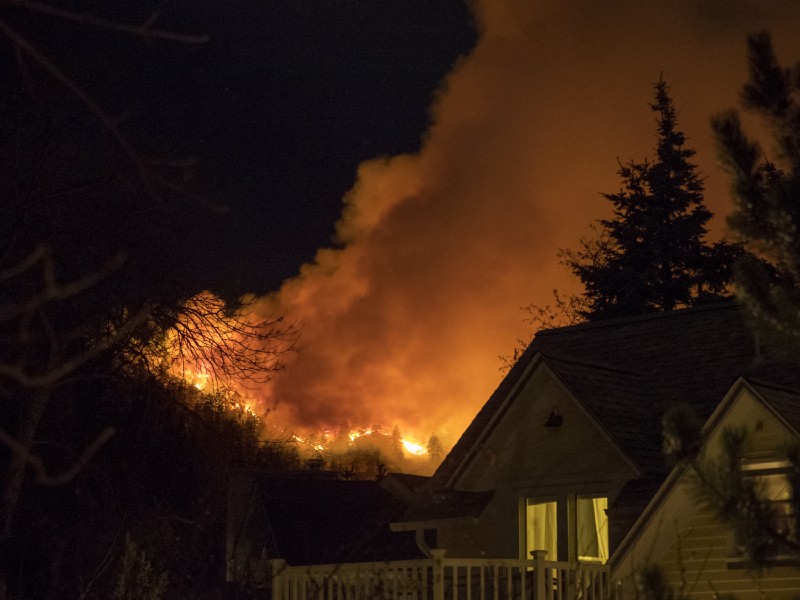 Smoke rises from a wildfire near homes Sunday, March 19, 2017, in Boulder, CO. CREDIT: Seth Frankel via AP