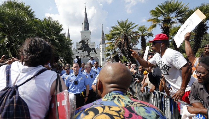Police guard the statue of Andrew Jackson from protesters seeking to take it down. CREDIT: AP Photo/Gerald Herbert