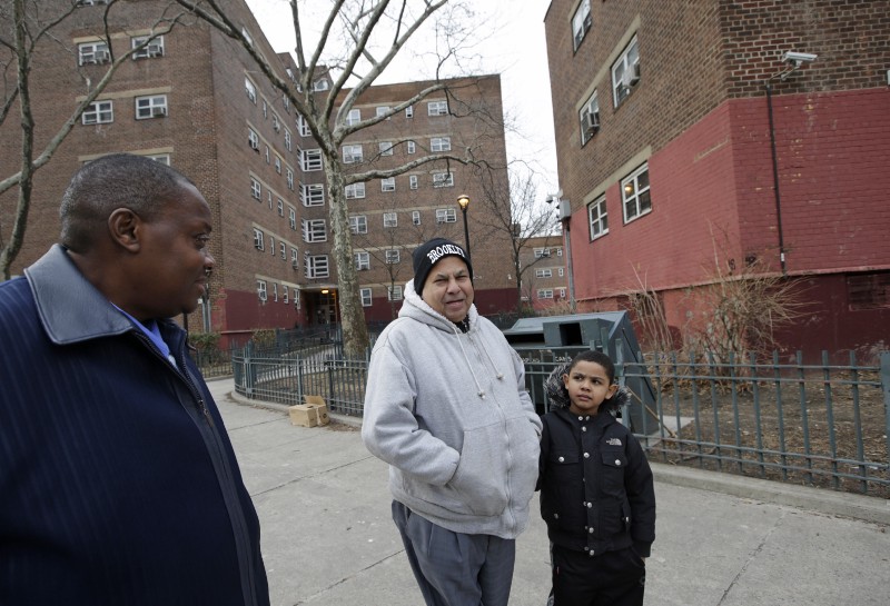 New York City residents outside the Brownsville Houses public housing projects. AP Photo/Kathy Willens