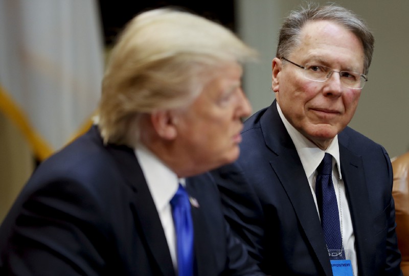 NRA Chief Executive Officer Wayne LaPierre listens at right as President Donald Trump speaks. CREDIT: AP Photo/Pablo Martinez Monsivais
