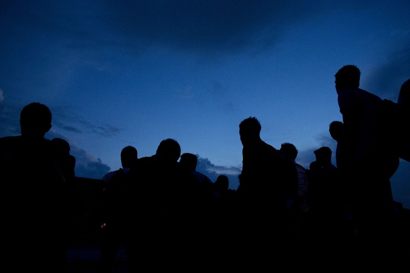 I n this June 19, 2014 photo, a Central American migrants emerge from side streets to crowd onto the tracks, as a northbound freight train arrives in the station in Arriaga, Chiapas state, Mexico. CREDIT: AP Photo/Rebecca Blackwell