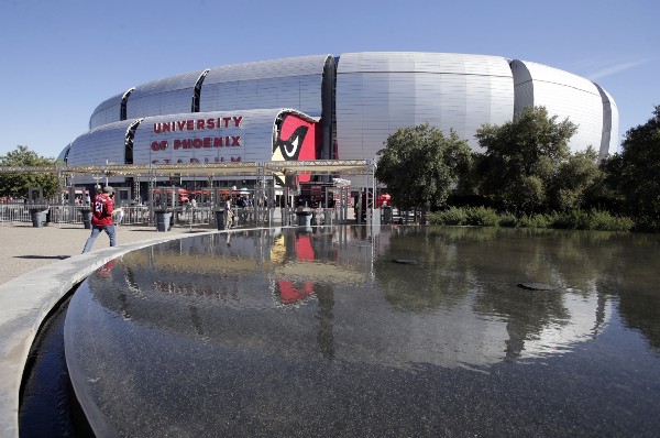 Fans arrive at University of Phoenix Stadium prior to an NFL football game between the New York Jets and the Arizona Cardinals, Monday, Oct. 17, 2016, in Glendale, Ariz. CREDIT: AP Photo/Rick Scuteri
