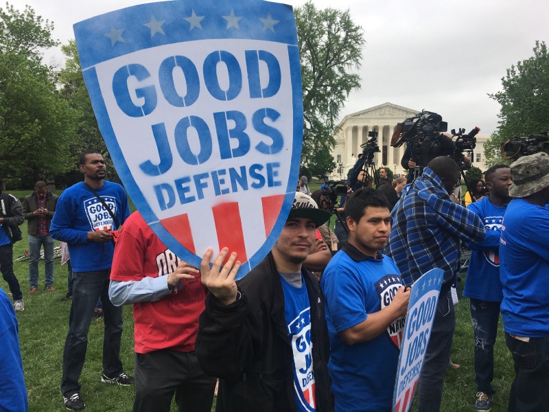 Workers hold signs created by Good Jobs Nation. CREDIT: Kira Lerner