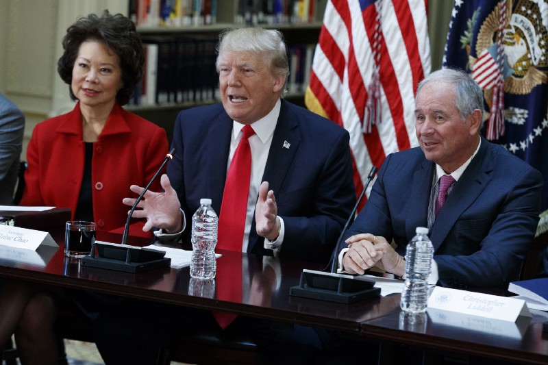 President Donald Trump with Transportation Secretary Elaine Chao and Blackstone Group CEO Stephen Schwarzman. CREDIT: AP Photo/Evan Vucci