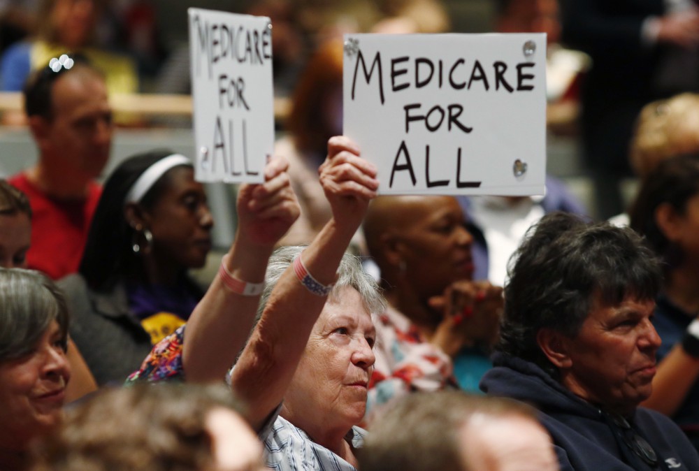 Constituents hold up placards as U.S. Rep. Mike Coffman, R-Colo., speaks during a town hall meeting in a hall on the campus of the University of Colorado Medical School late Wednesday, April 12, 2017, in Aurora, Colo. Town halls have become a risky proposition for GOP members of Congress since the election of President Donald Trump. CREDIT: AP Photo/David Zalubowski