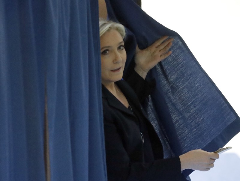 Marine Le Pen exits a polling booth before voting for the first-round of the presidential election in Henin-Beaumont, northern France, Sunday, April 23, 2017. CREDIT: AP Photo/Frank Augstein