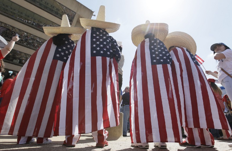 Julio Arellano, right, stands with his children from left, Brisa Arellano, Julio C. Arellano and Israel Arellano and during a protest rally in downtown Dallas, Sunday, April 9, 2017. CREDIT: AP Photo/LM Otero