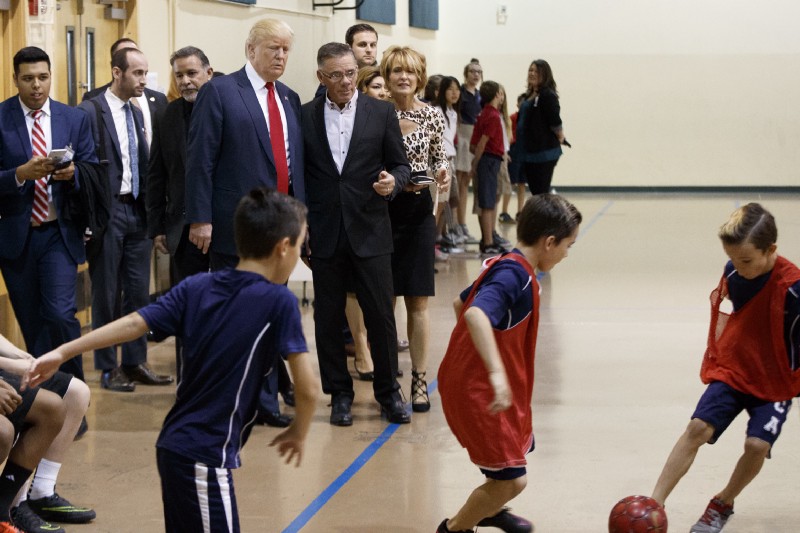 Republican presidential candidate Donald Trump watches students play soccer during a visit to the International Church of Las Vegas, and International Christian Academy, Wednesday, Oct. 5, 2016, in Las Vegas. CREDIT: AP Photo/ Evan Vucci