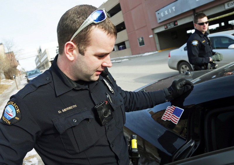 Police officers in Duluth, MN, wearing body cameras. CREDIT: AP Photo/Jim Mone, File