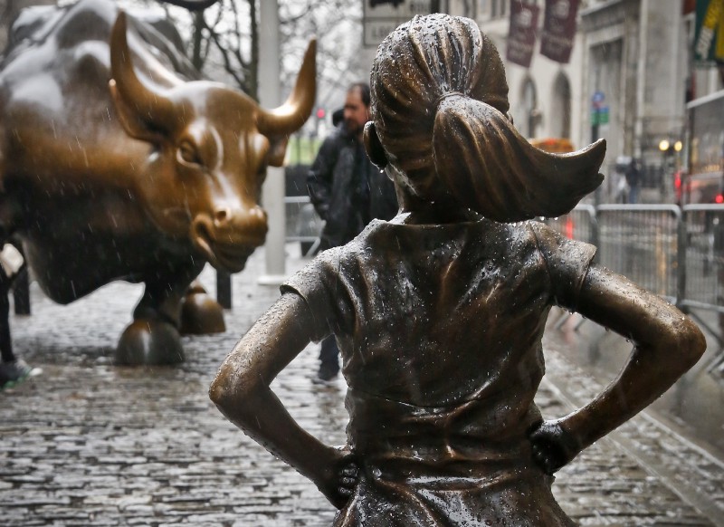 The “Fearless Girl” statue, created by Kristen Visbal, stands across from the “Charging Bull” statue, Monday, March 27, 2017, in New York. CREDIT: AP Photo/Bebeto Matthews