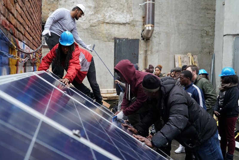Trainees with Washington, D.C. solar company WDC Solar practice installing solar panels. CREDIT: Nexus Media