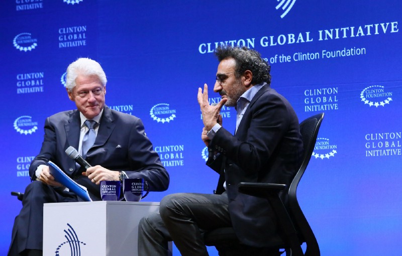 President Bill Clinton and Hamdi Ulukaya, Founder and CEO, Chobani and Founder of the Tent Foundation, discuss the role of the private sector in helping refugees at the Clinton Global Initiative Winter Meeting in New York, Thursday, Feb. 4, 2016. CREDIT: Stuart Ramson/AP Images for Tent Foundation