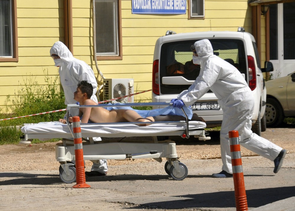 Turkish experts evacuate a victim of a suspected chemical weapons attacks in the Syrian city of Idlib, at a local hospital in Reyhanli, Turkey, on April 4. A suspected chemical attack in a town in Syria’s rebel-held northern Idlib province killed dozens of people on Tuesday, opposition activists said, describing the attack as among the worst in the country’s six-year civil war. CREDIT: DHA-Depo Photos via AP