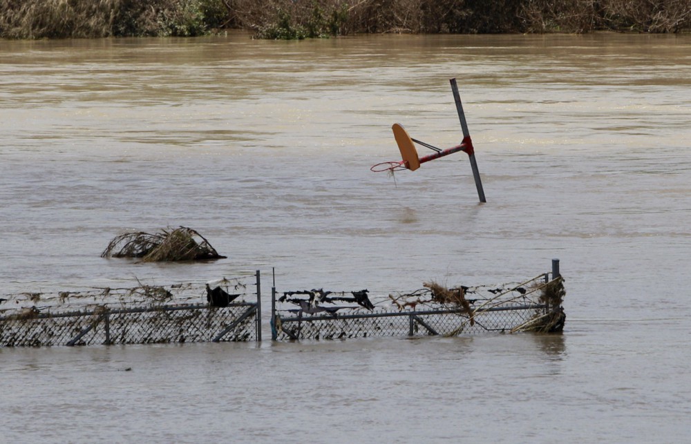 A basketball hoop appears above flood water from The Rio Grande in Laredo, Texas, July 15, 2010. CREDIT: AP/Eric Gay