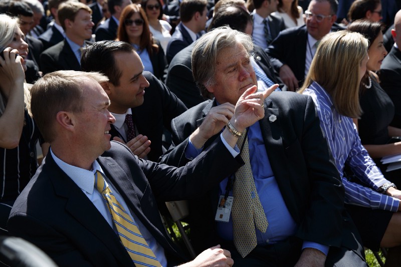 Budget Director Mick Mulvaney, left, talks with White House chief strategist Steve Bannon in the Rose Garden of the White House in Washington, Monday, April 10, 2017. CREDIT: AP Photo/Evan Vucci