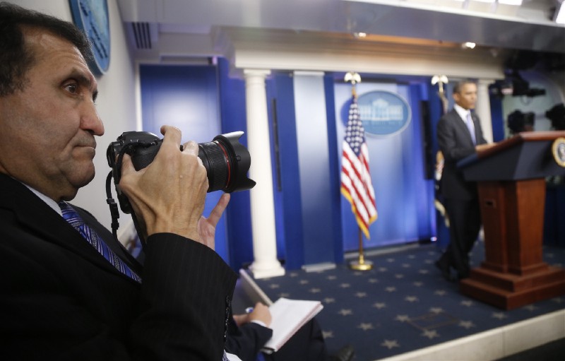 Official White House photographer Pete Souza photographs President Barack Obama during his end-of-the-year news conference at the White House in Washington, Friday, Dec. 20, 2013. CREDIT: AP Photo/Charles Dharapak