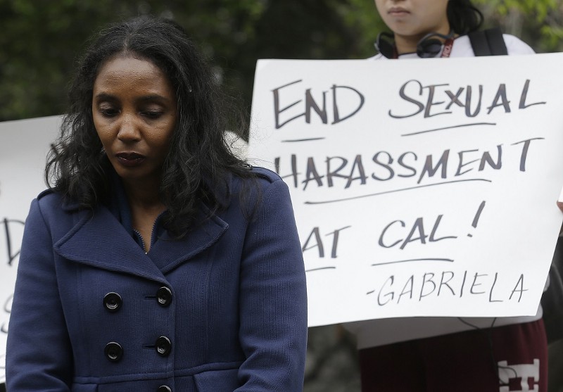 Tyann Sorrell listens to speakers at a news conference on the University of California campus in Berkeley, Calif. A legal settlement has been reached between the University of California, Berkeley, the former law school dean, Sujit Choudhry, and his former assistant, Sorrell, who said Choudhry sexually harassed her. CREDIT: AP/Jeff Chiu