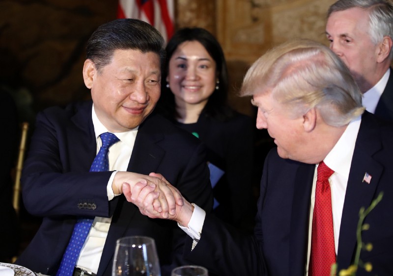 President Donald Trump, right, shakes hands with Chinese President Xi Jinping during a dinner at Mar-a-Lago, Thursday, April 6, 2017, in Palm Beach, Fla. CREDIT: AP Photo/Alex Brandon