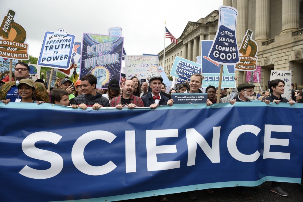 Climate scientist Michael Mann and science educator Bill Nye, center, lead the March for Science in Washington on April 22, 2017. CREDIT: AP Photo/Sait Serkan Gurbuz