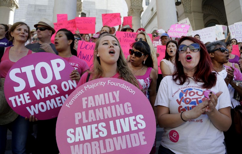 In this Sept. 9, 2015, file photo, Planned Parenthood supporters rally for women’s access to reproductive health care on “National Pink Out Day’’ at Los Angeles City Hall. CREDIT: AP Photo/Nick Ut, File