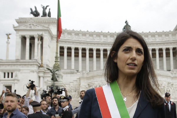 Rome’s Mayor Virginia Raggi leaves the Rome’s Vittoriano Unknown soldier monument, after laying a wreath, Thursday, June 23, 2016. The 5-Star Movement candidate in Rome, Virginia Raggi, a lawyer with a three-year stint as a city councilwoman, took 67.2 percent of the vote in a two-person runoff Sunday, becoming the corruption-stained capital city’s first female mayor and, at 37, also its youngest. (AP Photo/Gregorio Borgia)