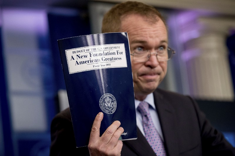 Budget Director Mick Mulvaney holds up a copy of President Donald Trump’s proposed fiscal 2018 federal budget as he speaks to members of the media in the Press Briefing Room of the White House in Washington, Tuesday, May 23, 2017. CREDIT: AP Photo/Andrew Harnik