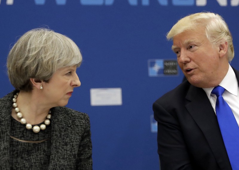 U.S. President Donald Trump, right, speaks to British Prime Minister Theresa May during in a working dinner meeting at the NATO headquarters during a NATO summit of heads of state and government in Brussels on Thursday, May 25, 2017. CREDIT: AP Photo/Matt Dunham, Pool