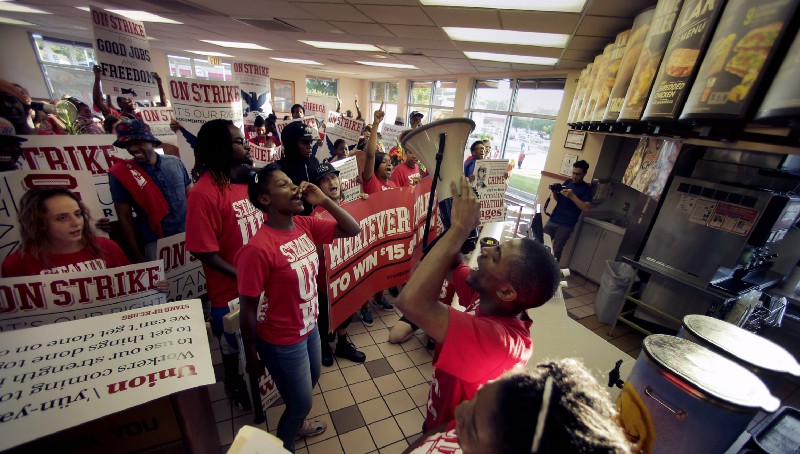 Fight for 15 protesters in a Kansas City, Missouri Taco Bell in 2014. CREDIT: AP Photo/Charlie Riedel
