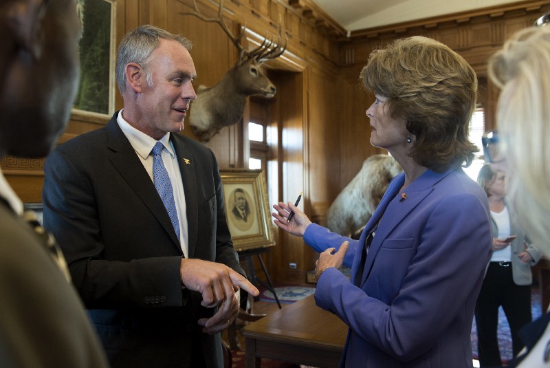 Interior Secretary Ryan Zinke with Sen. Lisa Murkowski (R-AK) after signing an order lifting a moratorium on new coal leases on federal lands and a related order on coal royalties. CREDIT: AP Photo/Molly Riley
