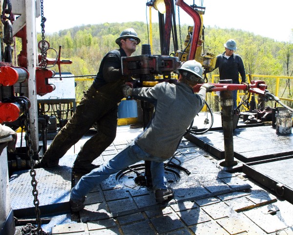 Workers move a section of well casing at a Chesapeake Energy natural gas well site in Pennsylvania. CREDIT: AP Photo/Ralph Wilson