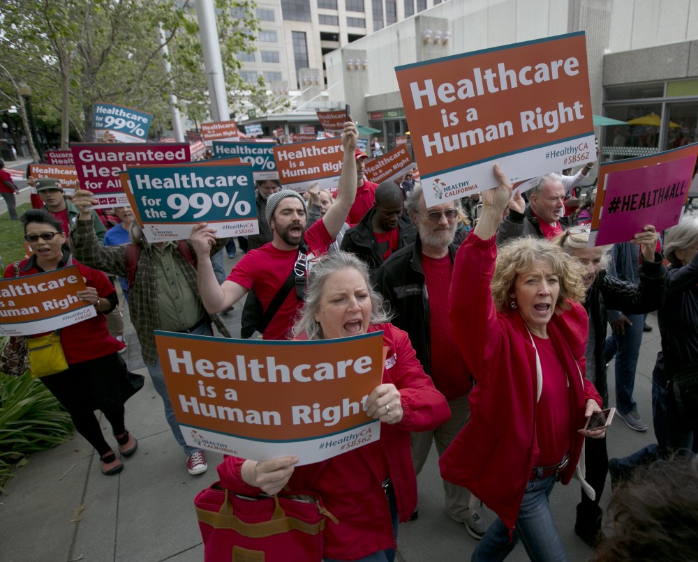 Supporters of single-payer health care march to the Capitol, Wednesday, April 26, 2017, in Sacramento, Calif. A bill, SB562, by Democratic State Senators Ricardo Lara and Toni Atkins, would substantially remake the health care system of the nation’s most populous state by eliminating insurance companies and guaranteeing coverage for everyone. CREDIT: AP Photo/Rich Pedroncelli