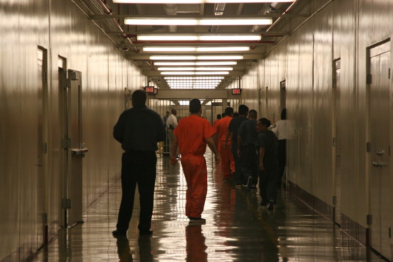 This April 13, 2009 photo shows a detainee at Immigration and Customs Enforcement’s Stewart Detention Center in Lumpkin, Ga., leaving the cafeteria after lunch to go back to their living units. CREDIT: AP Photo/Kate Brumback