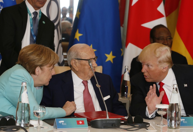 German Chancellor Angela Merkel, left, speaks with President Donald Trump during a multilateral weekend meeting in Brussels. CREDIT: AP Photo/Domenico Stinellis