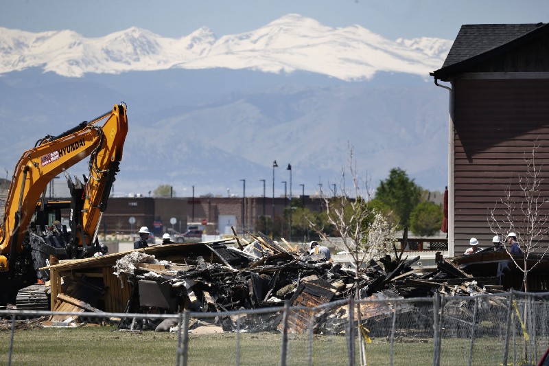 Workers dismantle the charred remains of a house destroyed by an Anadarko Petroleum natural gas line leak that caused an explosion that killed two people inside the house in Firestone, Colorado. CREDIT: AP Photo/Brennan Linsley