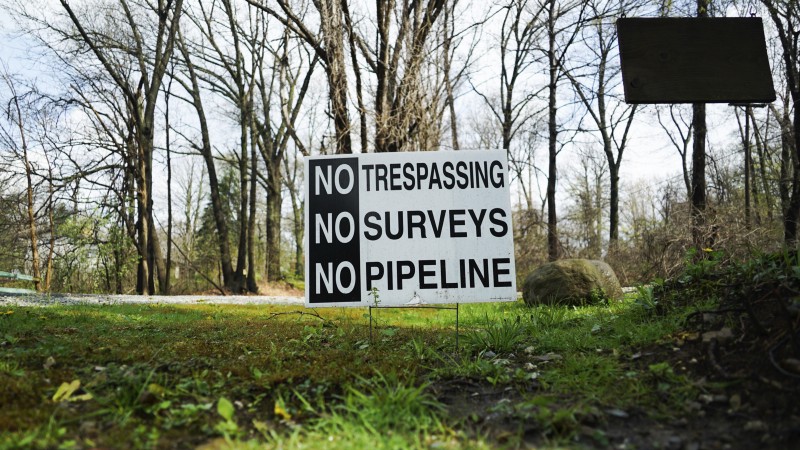 In this April 20, 2017 photo, a sign opposing a proposed pipeline sits in the front yard of a house in Green, Ohio. The town has hired a law firm to stop the pipeline from being built through the community. CREDIT: AP Photo/Dake Kang