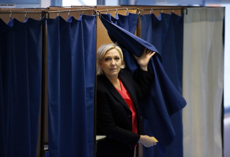 French far-right presidential candidate, Marine Le Pen exits a voting booth before casting her ballot in Henin Beaumont, France, Sunday, May 7, 2017. CREDIT: AP Photo/Francois Mori