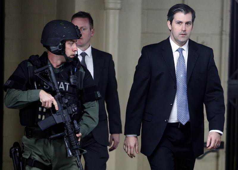 Fired Officer Michael Slager, right, leaving court in December after a judge declared a mistrial. Slager killed unarmed, fleeing Walter Scott near Charleston in 2015. CREDIT: AP Photo/Mic Smith, File