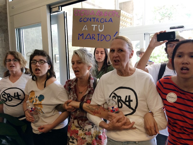 A group of protesters rally during a sit-in at the Texas Department of Insurance building in Austin, Texas on Monday, May 1, 2017. CREDIT: AP Photo/Meredith Hoffman